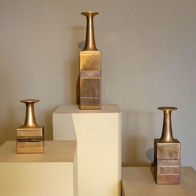 a set of three bronze Gambone vases